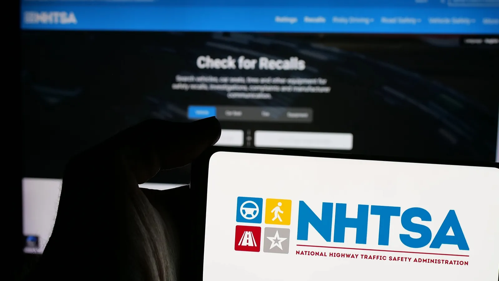 Cropped view of a smartphone with the website of the National Highway Traffic Safety Administration.