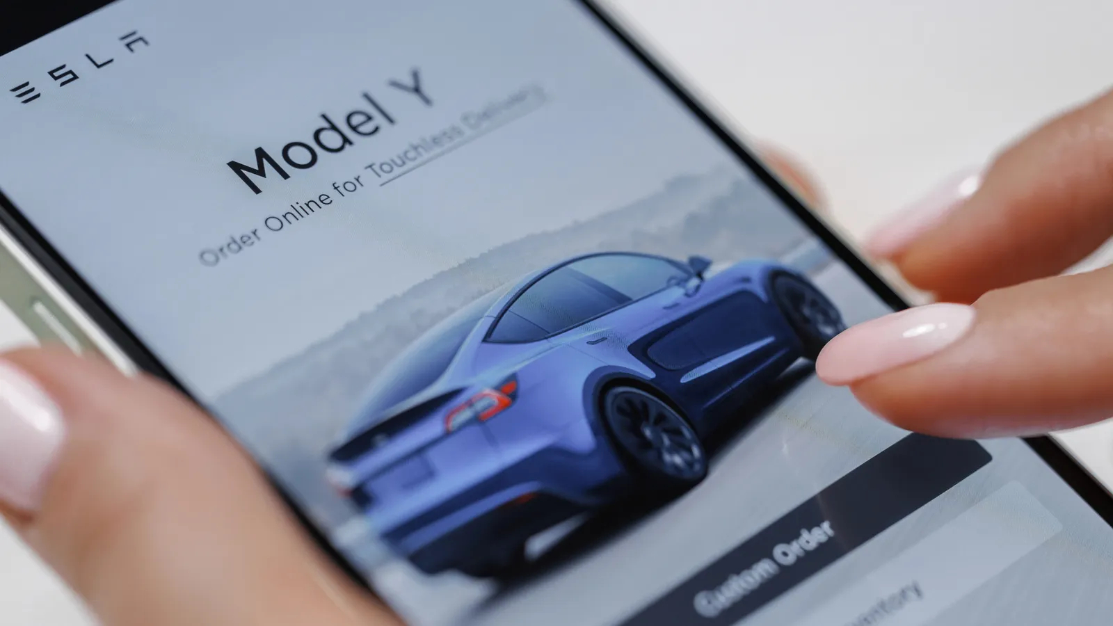 Close up of a Tesla on cellphone