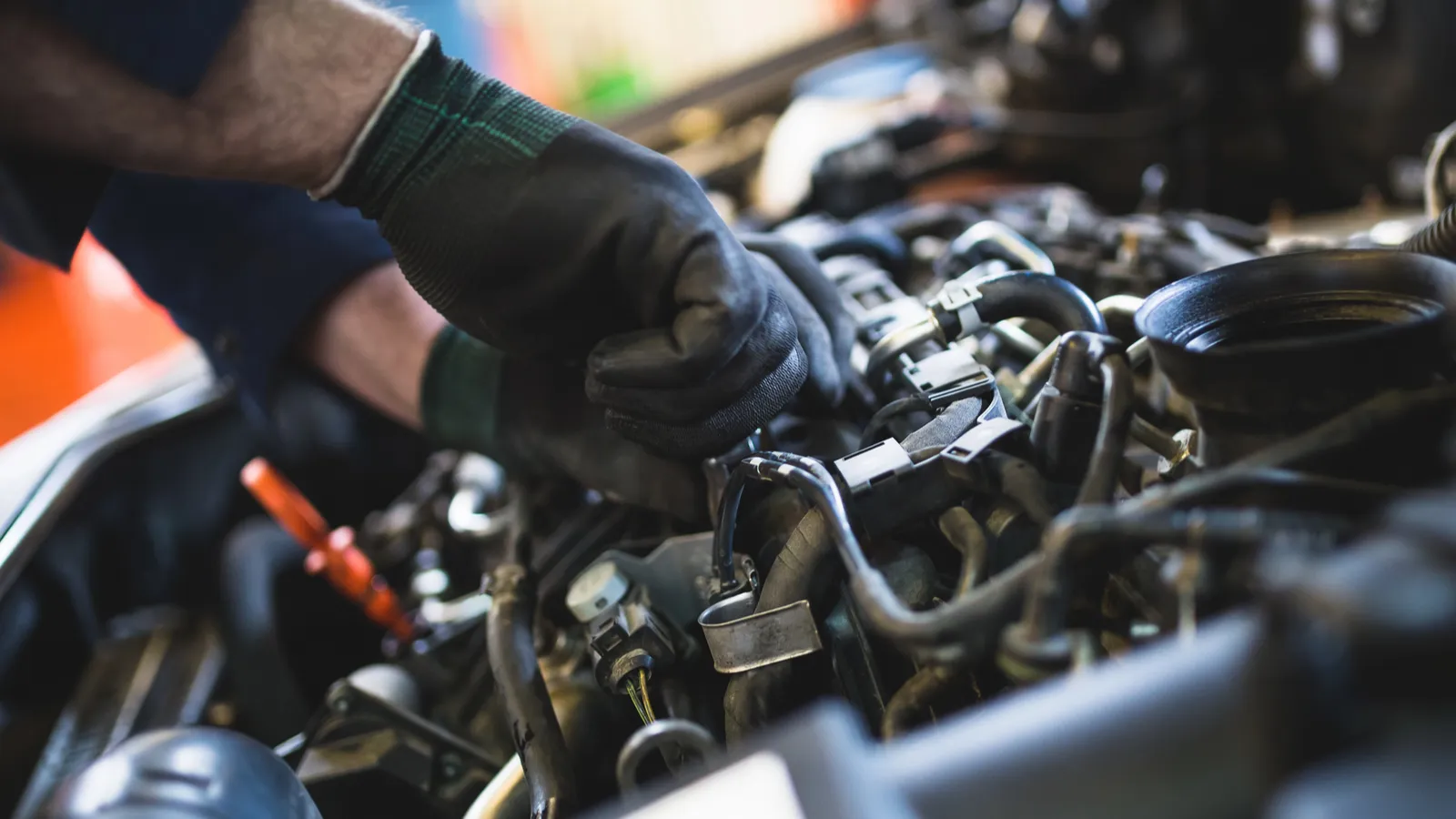 Car service mechanic working on automobile engine repair