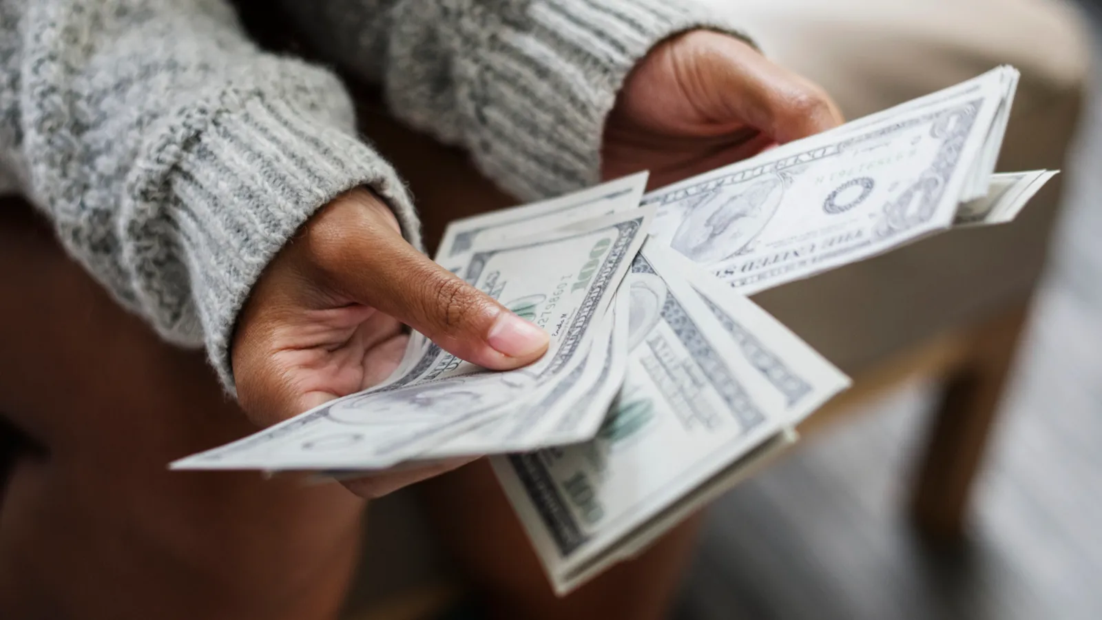 Closeup of woman counting money, dollars
