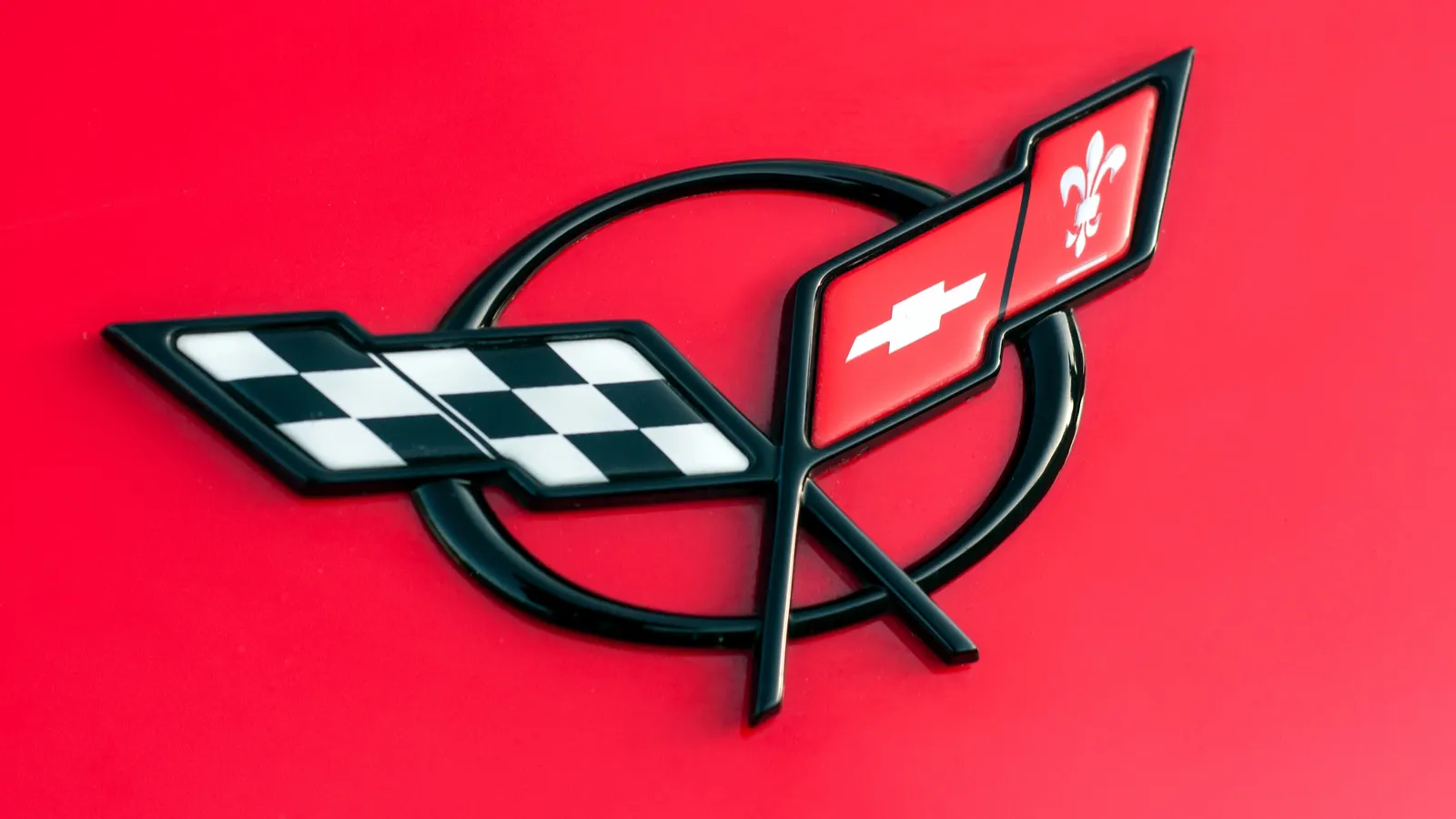Logo on red Chevrolet Corvette front parked     