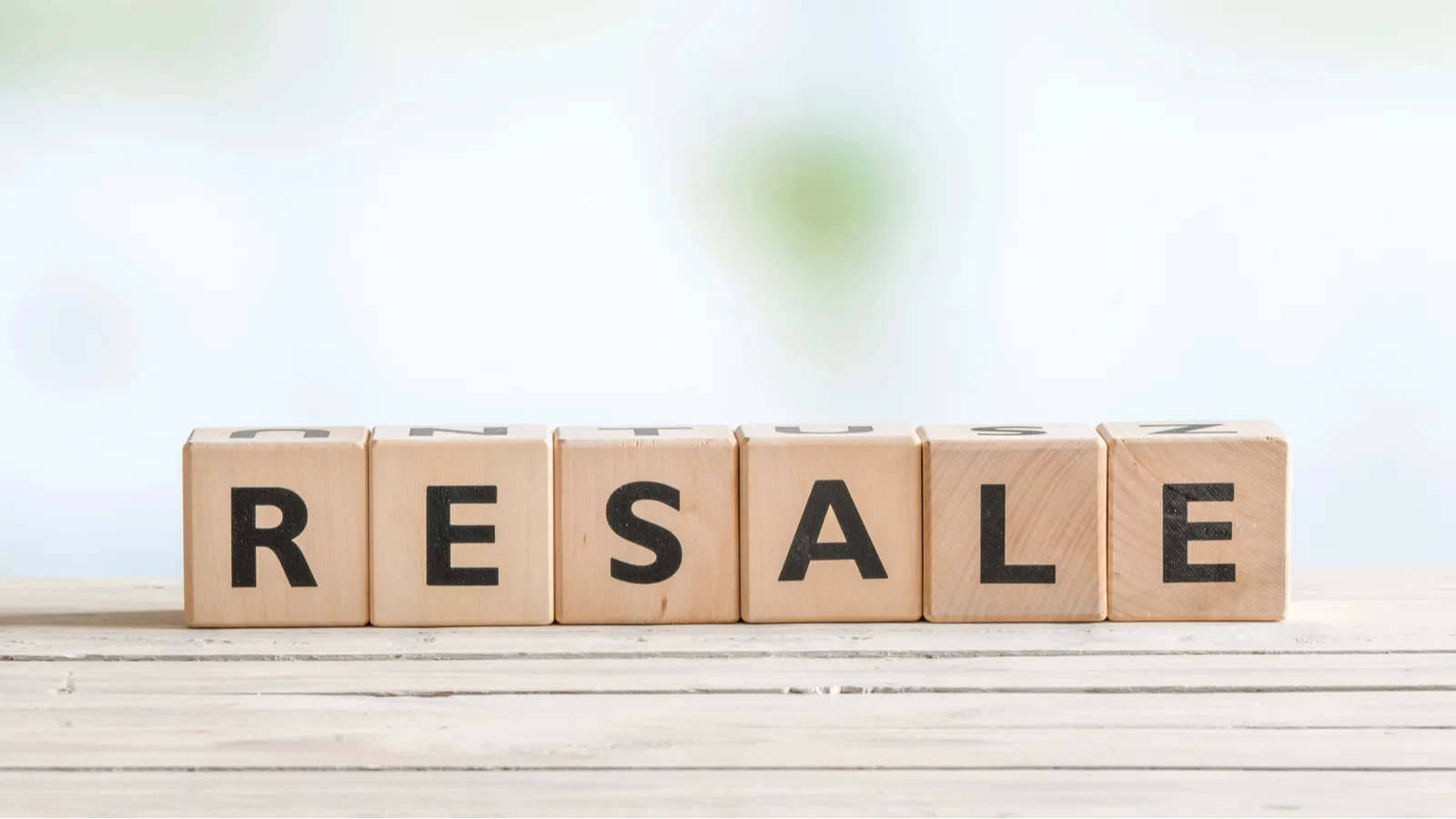 Resale sign on a wooden desk