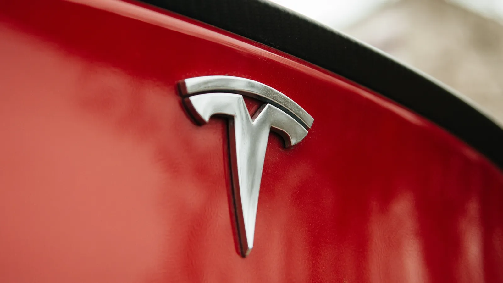 Tesla motors logo on a red car