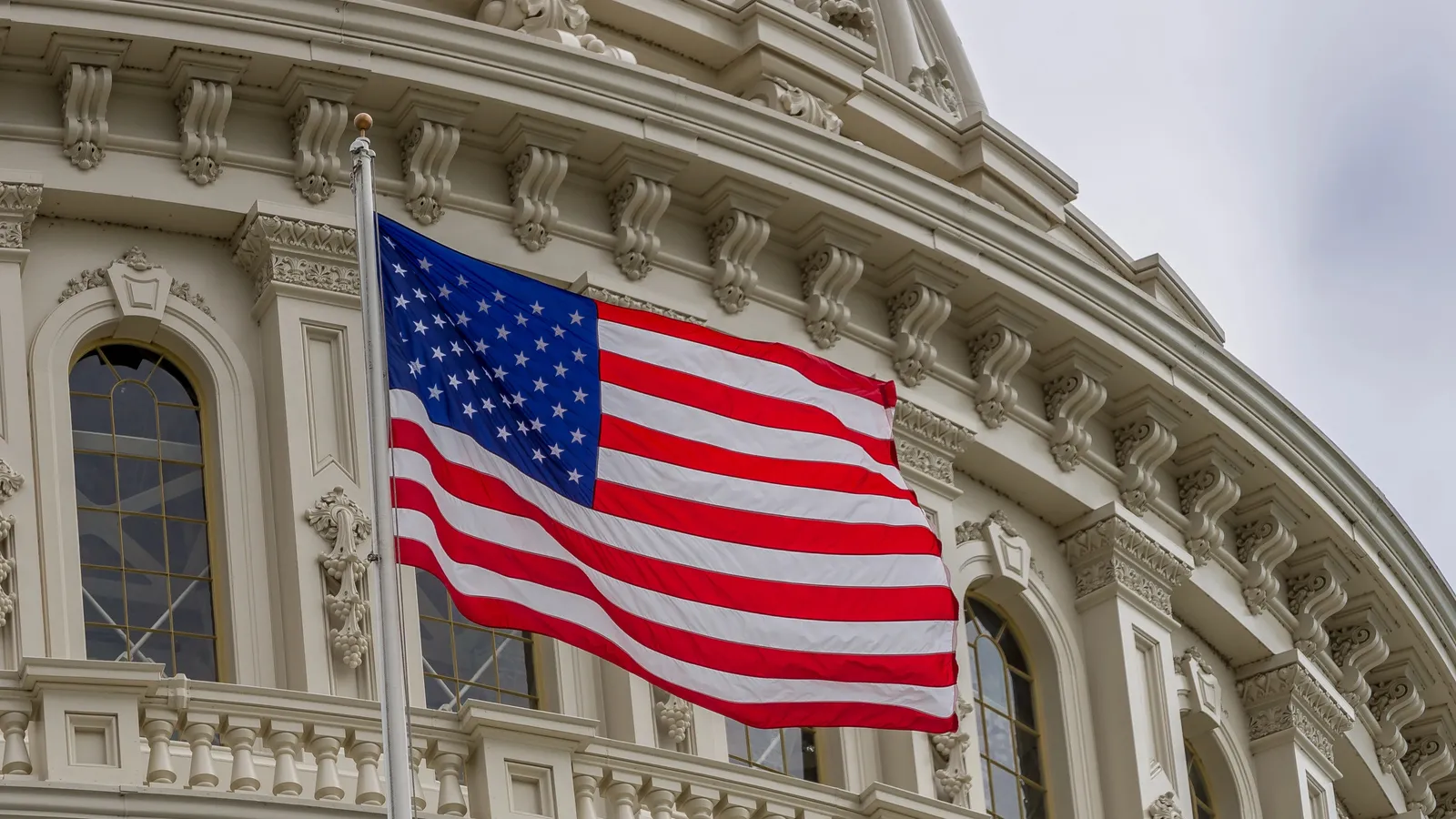 United States capitol building with waving American flag in Washington