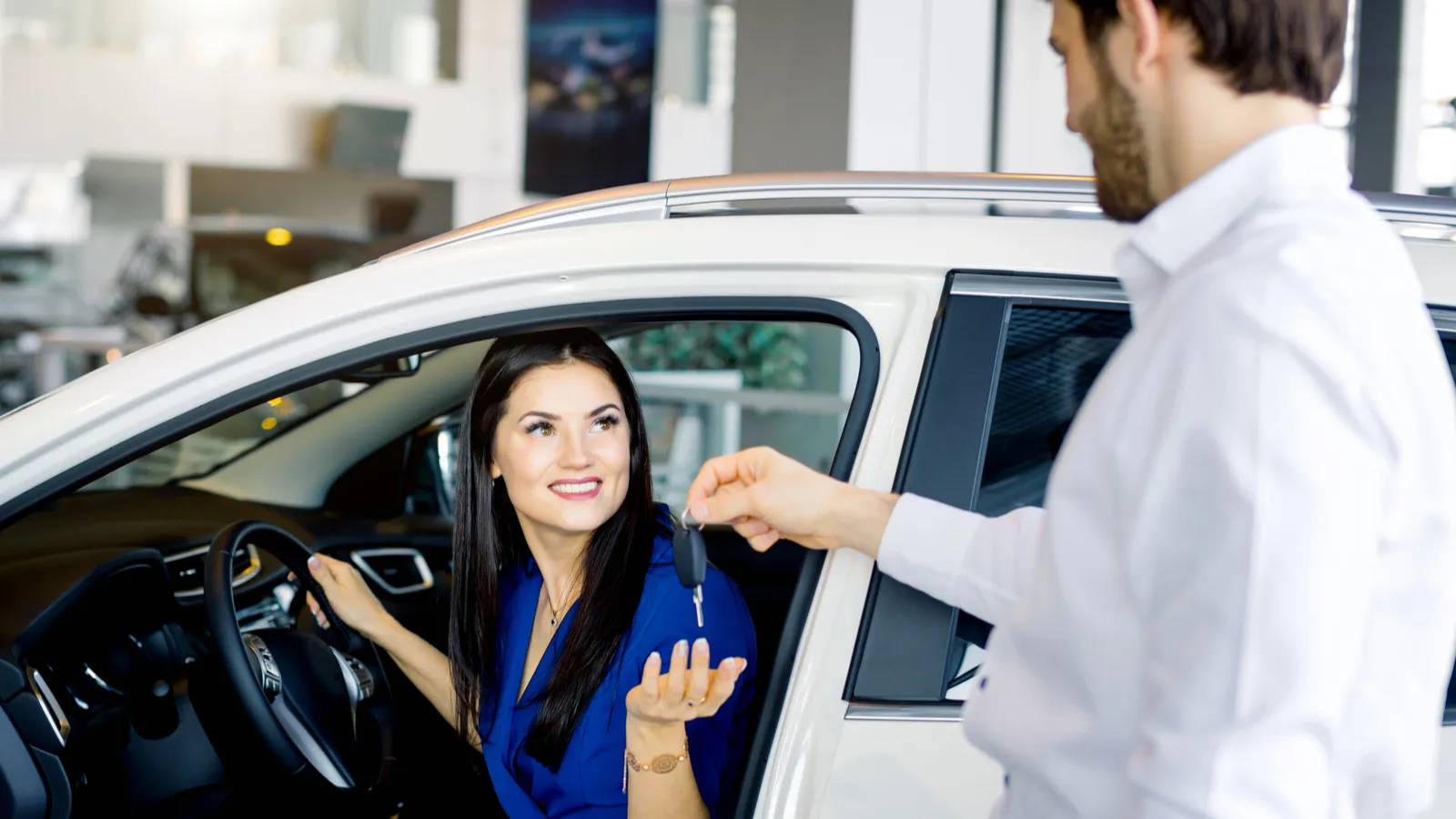 Women buying car happily