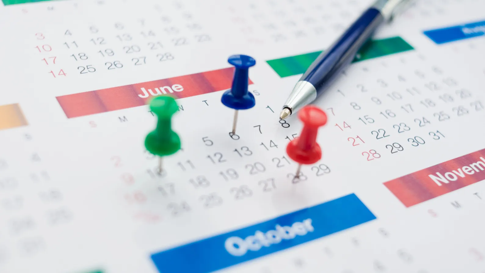 Business calendar with pins pinned on the month June.  