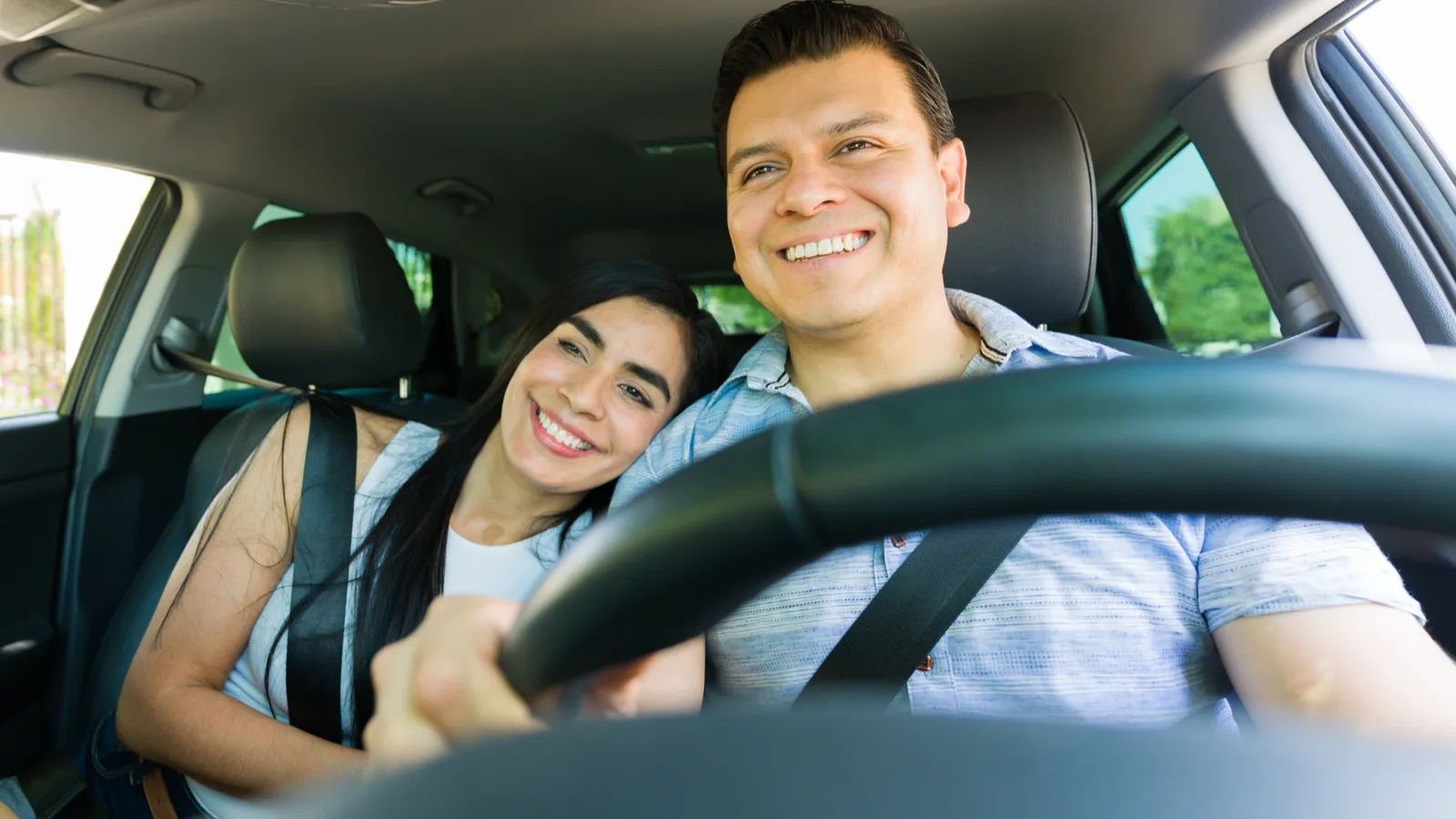 Happy couple enjoying car drive