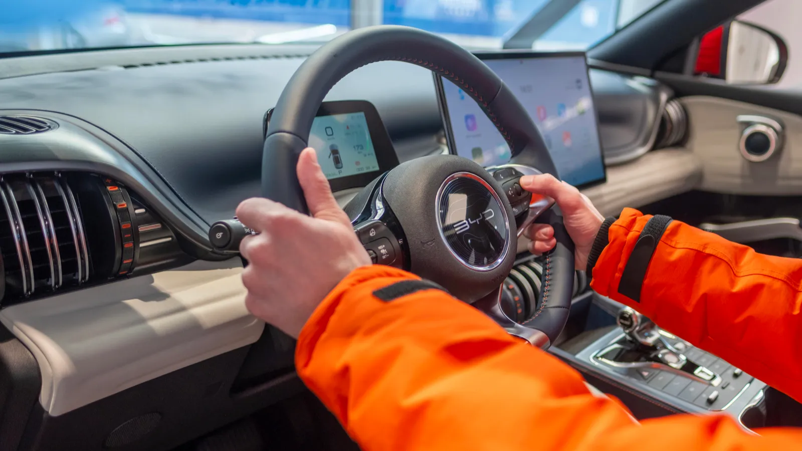 Male Hands on Steering Wheel Interior Cockpit of BYD Atto 3