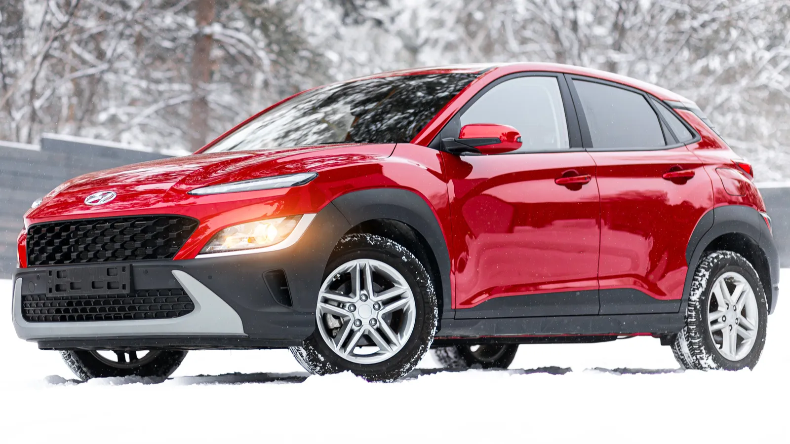 Red Hyundai Kona Electric parked in the snow